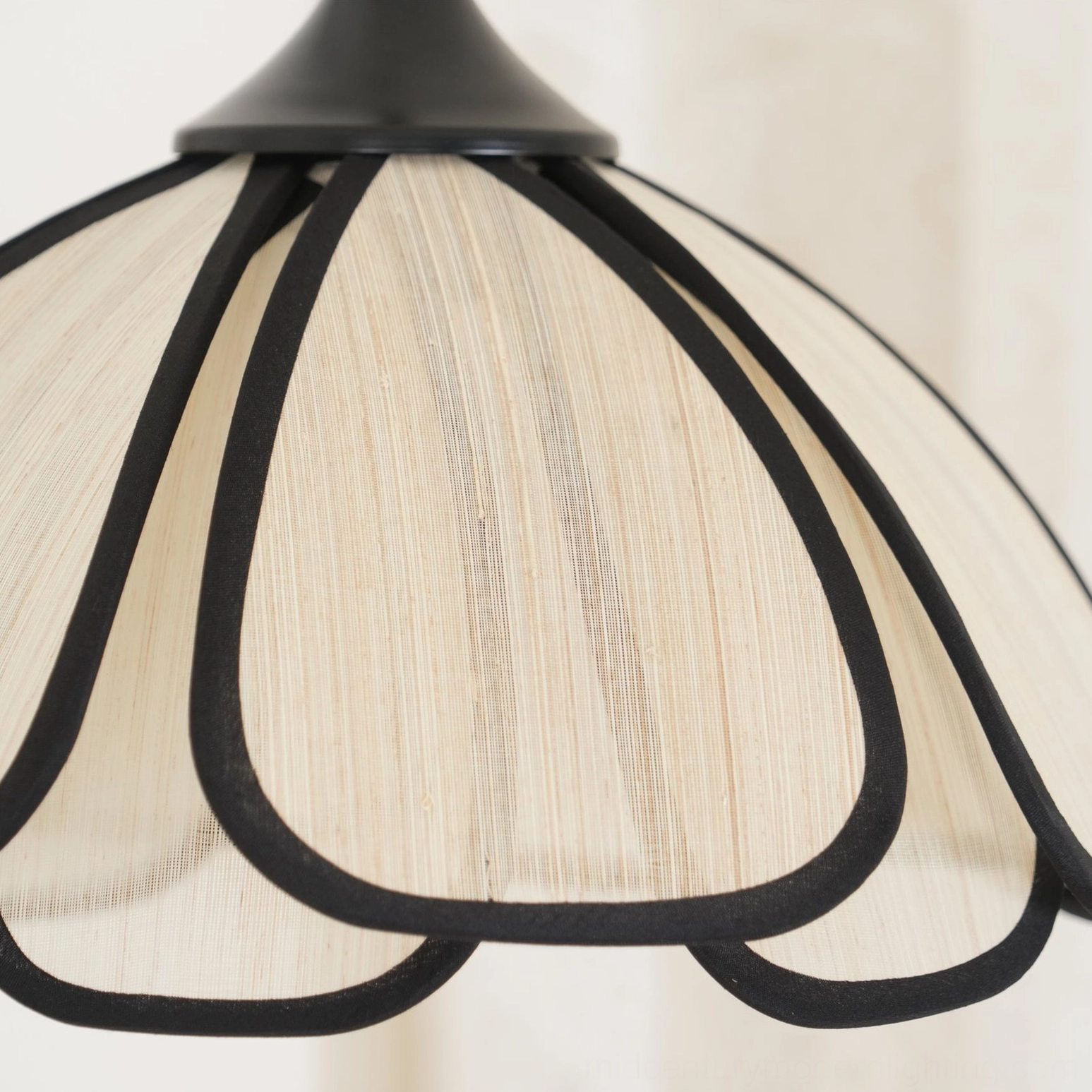 Extreme close-up of Okai lamp shade texture showing abaca fiber and black petal edging