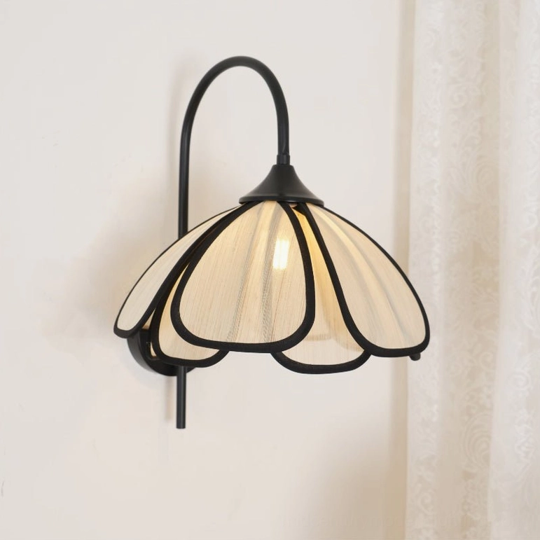 Okai floral sconce with exposed LED bulb, matte black metal hardware mounting detail
