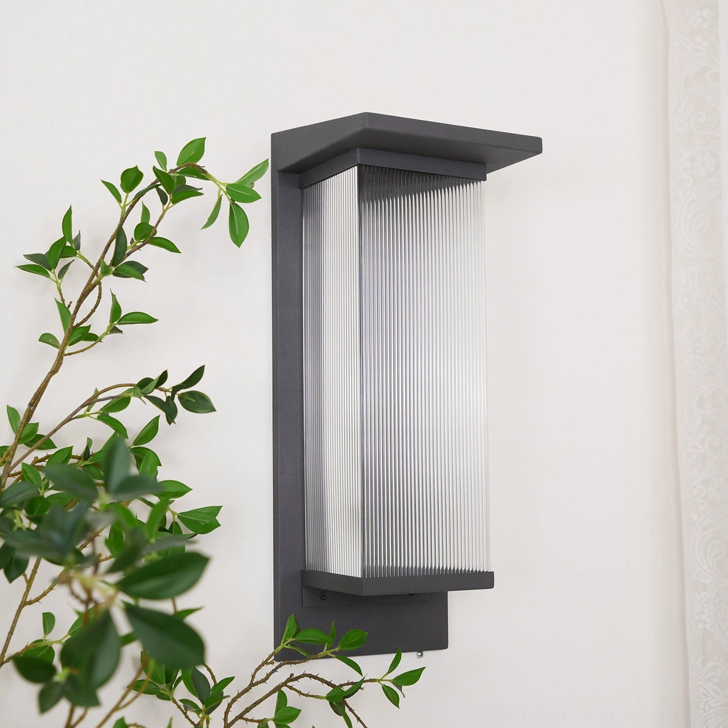 Oleron Box unlit close-up side view, matte black stainless steel construction, architectural minimalist frame, professional outdoor lighting