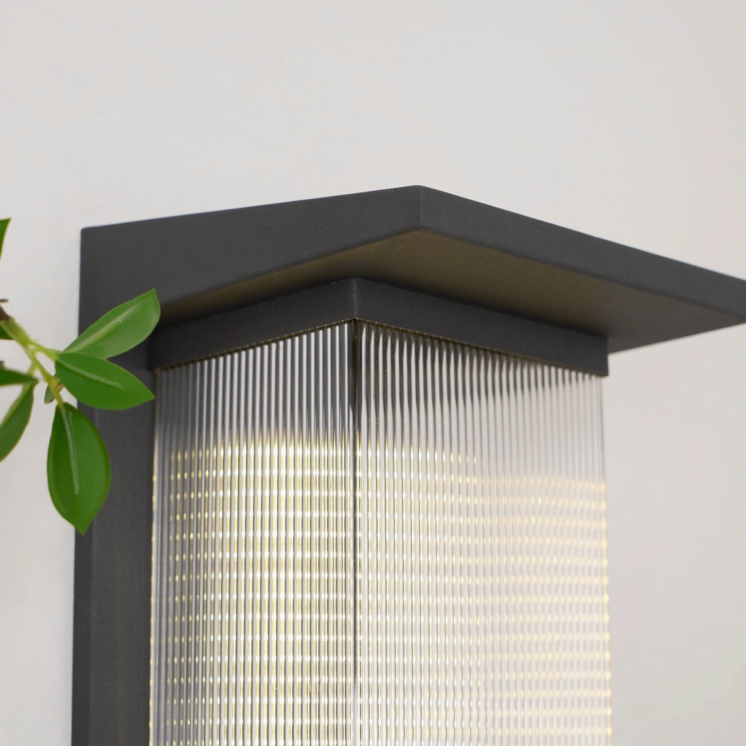 Oleron Box close-up mounting detail, LED lamp housing, illuminated ribbed glass, stainless steel hardware, professional outdoor installation