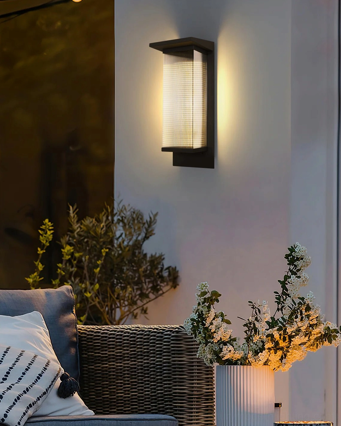 Oleron Box outdoor wall lamp detail shot, matte black frame, textured glass shade, architectural minimalist construction, professional lighting
