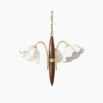 Olina flower ceramic chandelier with four light heads, ruffled white ceramic shades, brass gold accents and dark wood rod frame - overhead studio view