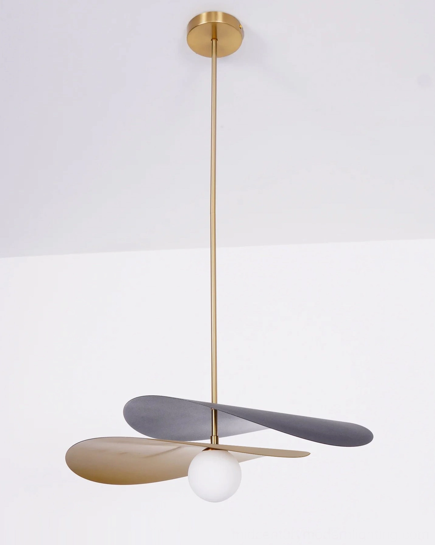 Olivia mid-century pendant light suspended in neutral interior space showing floating effect