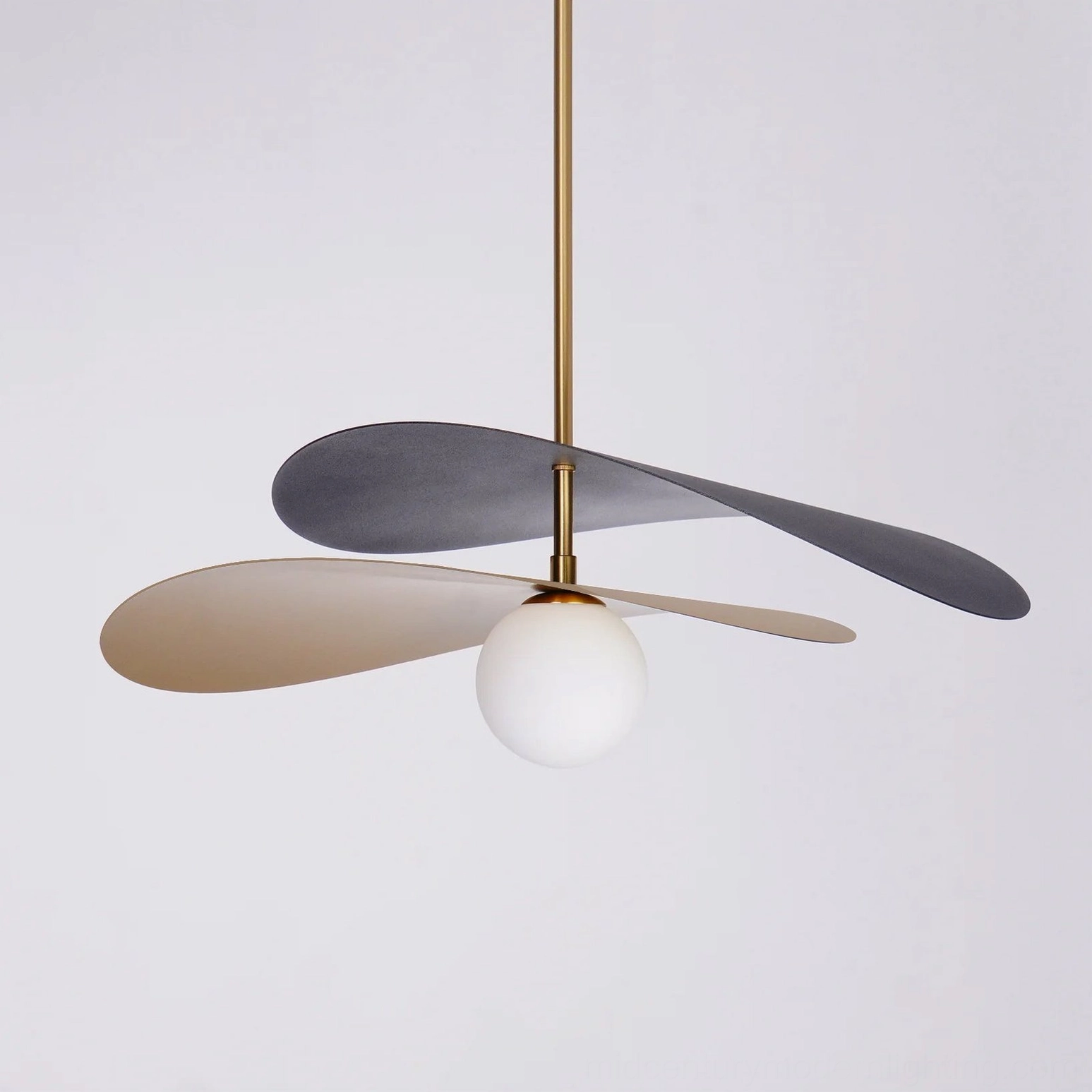 Close-up detail of Olivia pendant light frosted white glass globe bulb beneath brass suspension rod