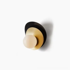 Olivia modern wall sconce with black and brass dual-tone metal discs and frosted glass globe on white background