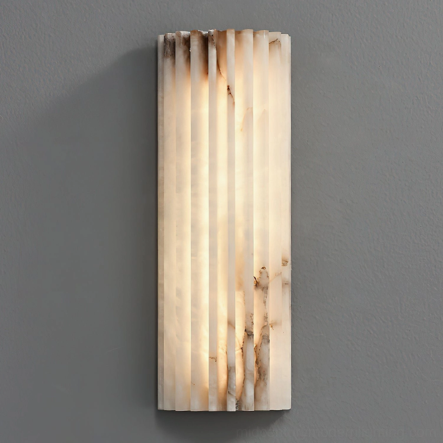 Illuminated Ondas alabaster wall lamp in bedroom setting with warm ambient lighting atmosphere