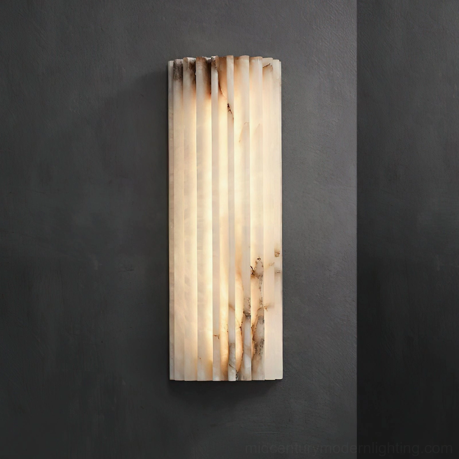 Ondas alabaster wall sconce with integrated LED warm light creating atmospheric glow through translucent stone