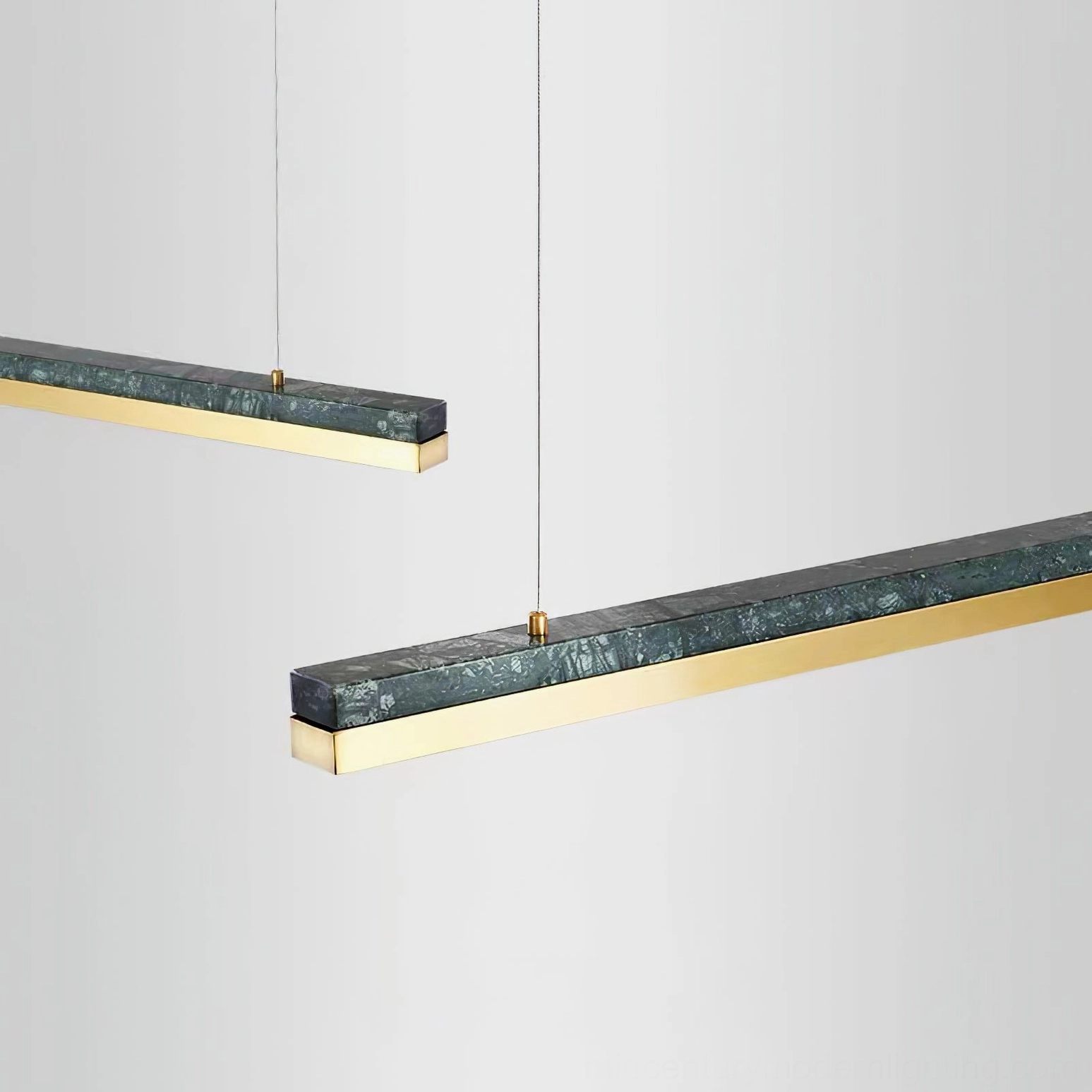 Two One Word pendant lights suspended side by side, showcasing dark green marble detail and brass metal accents