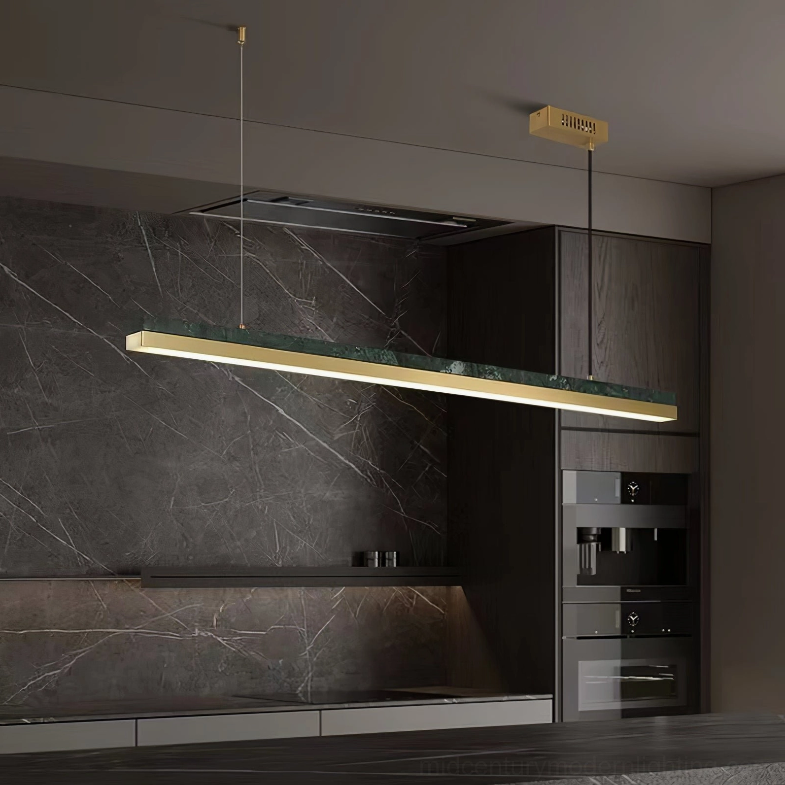 One Word pendant light installed above modern luxury kitchen island, warm brass lighting over dark marble