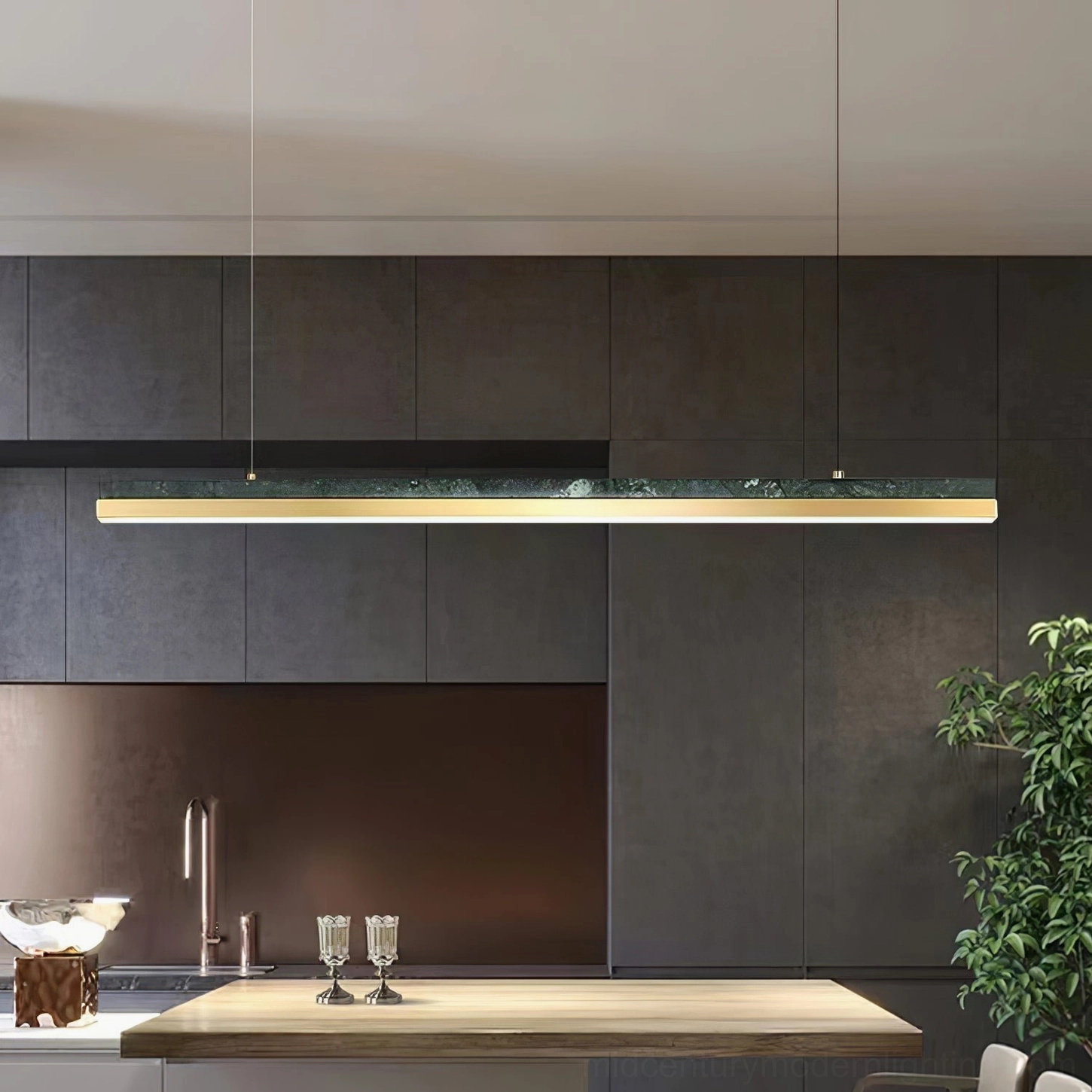 One Word pendant light in minimalist kitchen dining space with dark cabinetry and wooden table