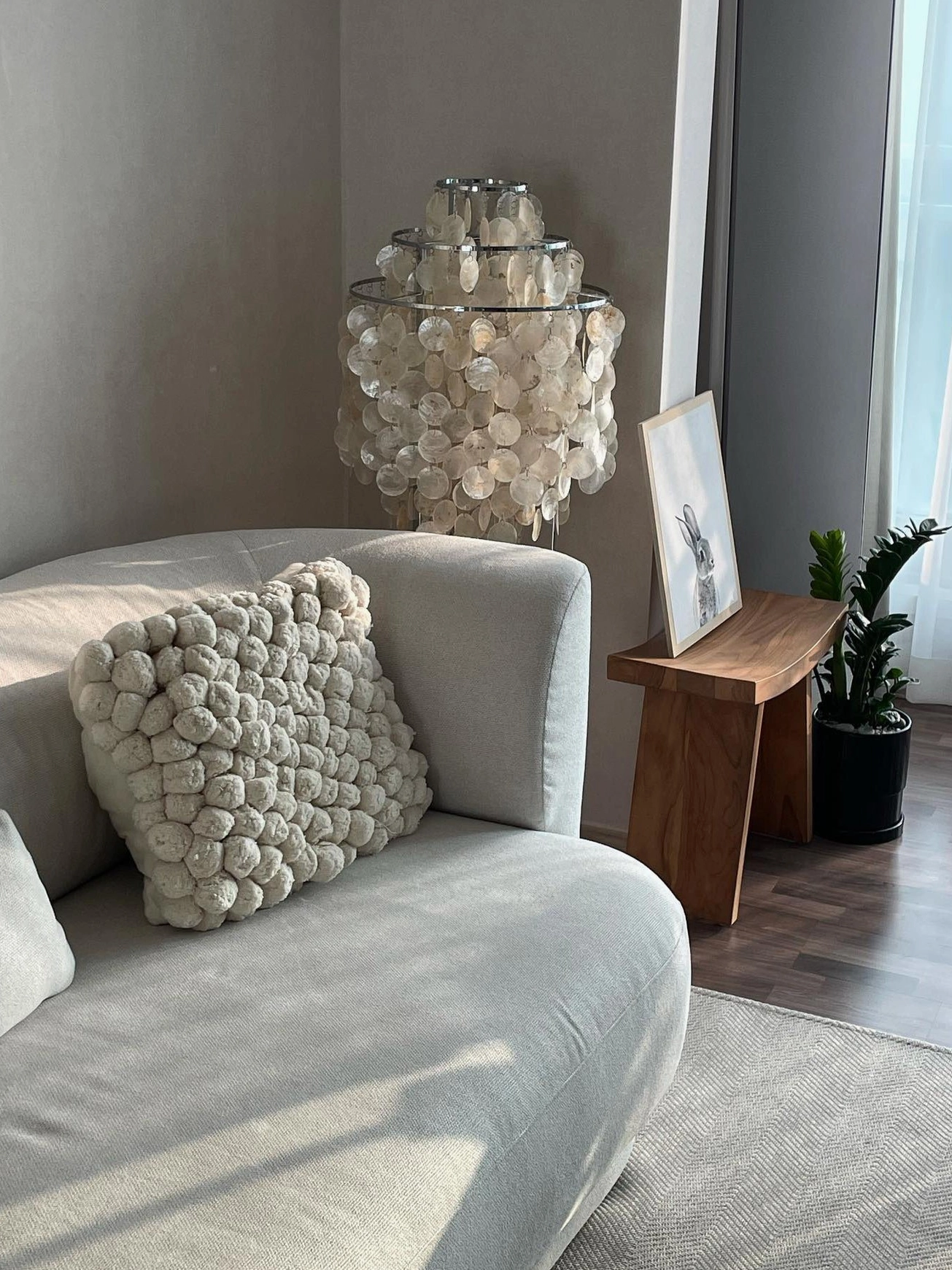 Contemporary shell floor lamp installation in open-plan minimalist living space