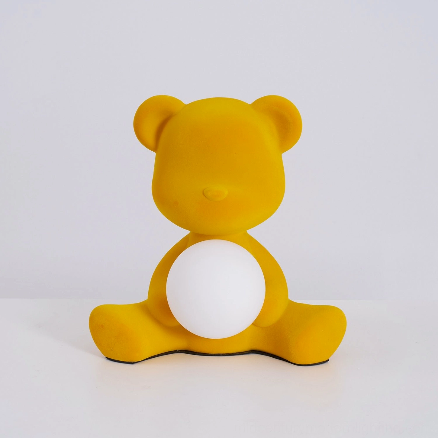 Orange teddy bear table lamp in natural daylight window setting