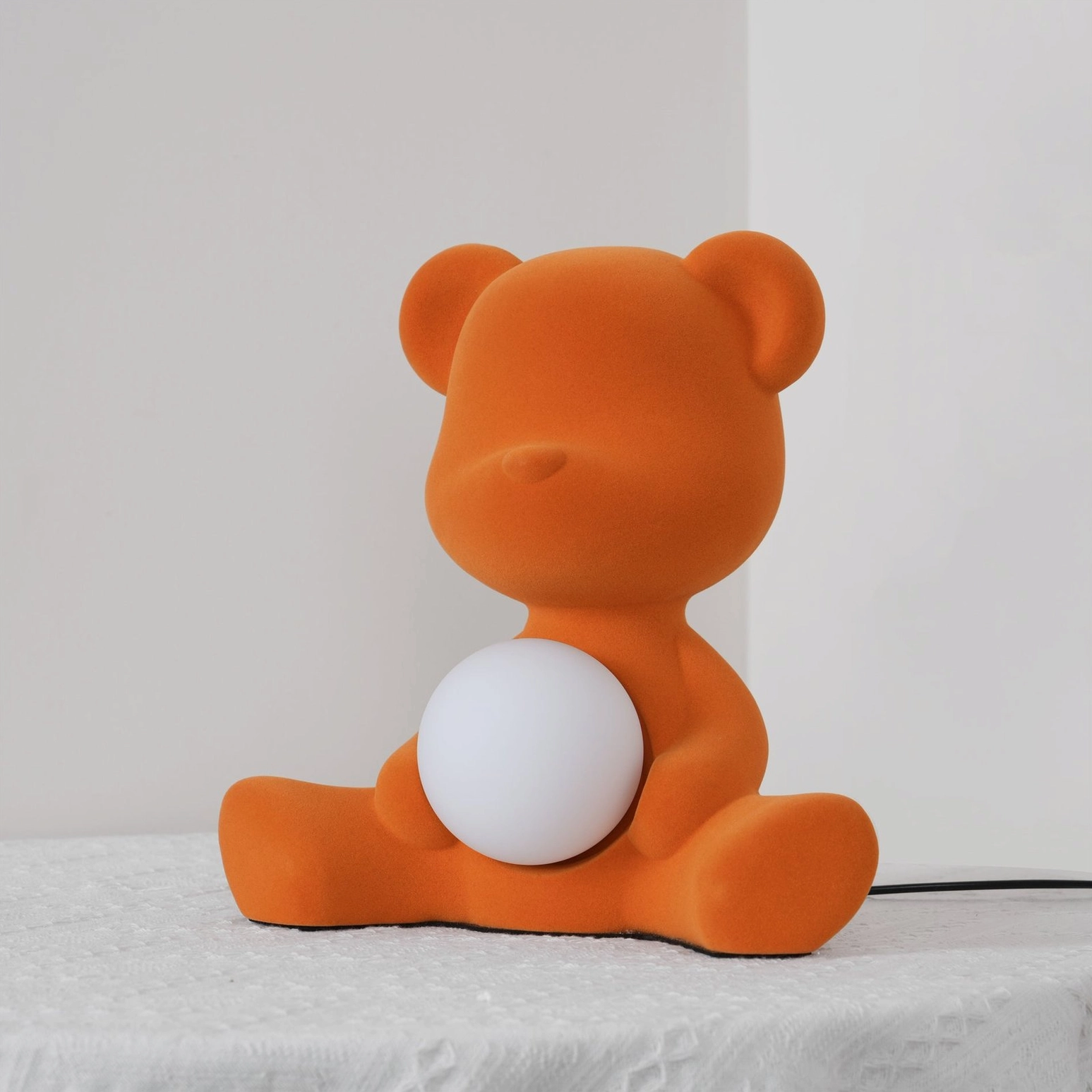 Orange teddy bear table lamp product view with illuminated sphere detail