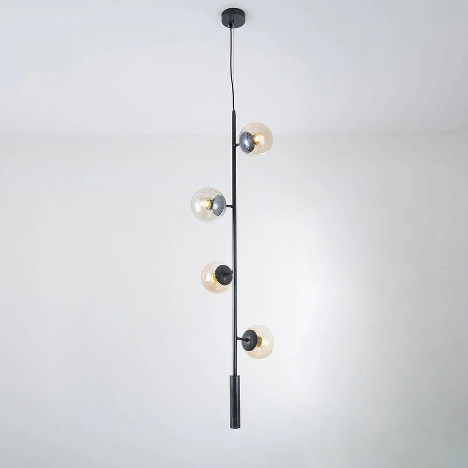 Amber orb pendant light with black frame creating warm golden ambient lighting