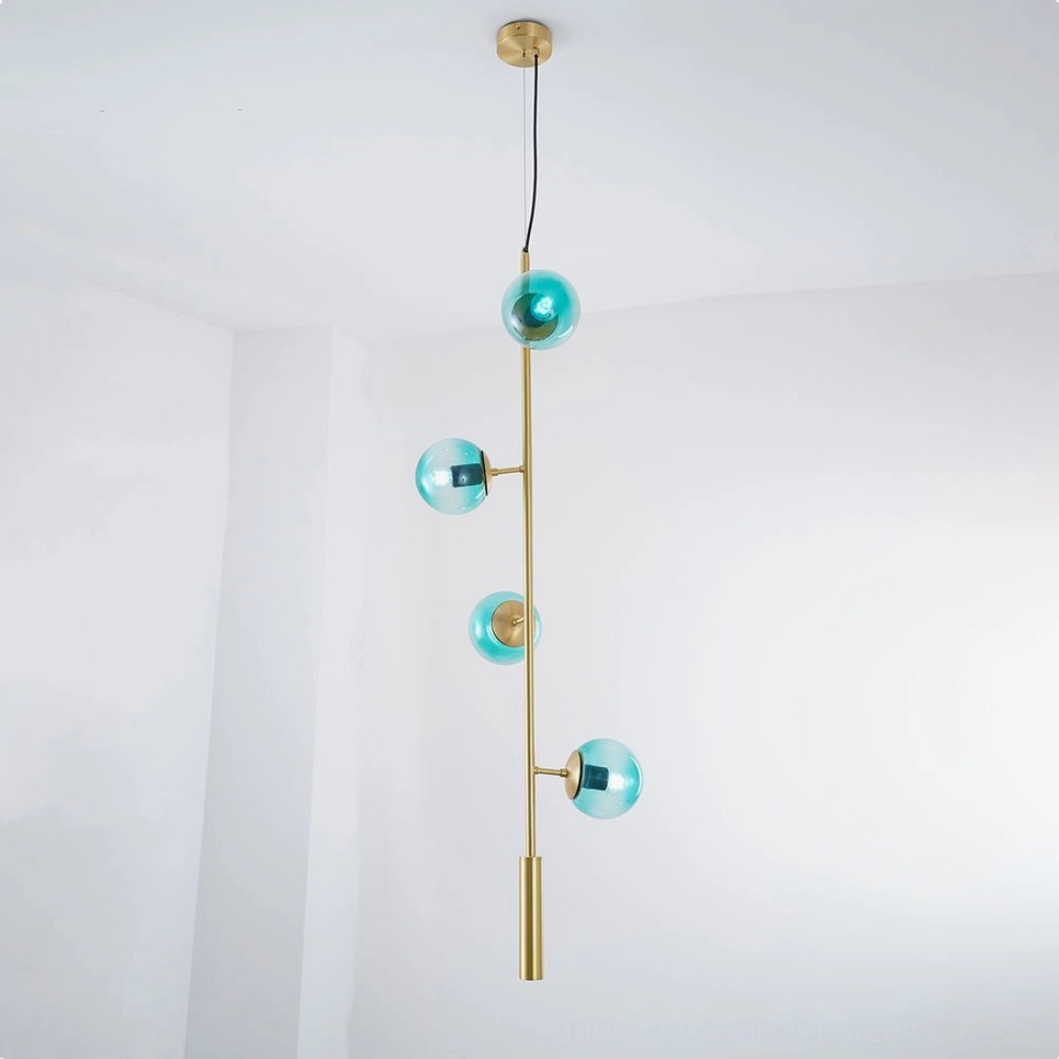 Blue orb pendant light with brass base creating soft diffused illumination