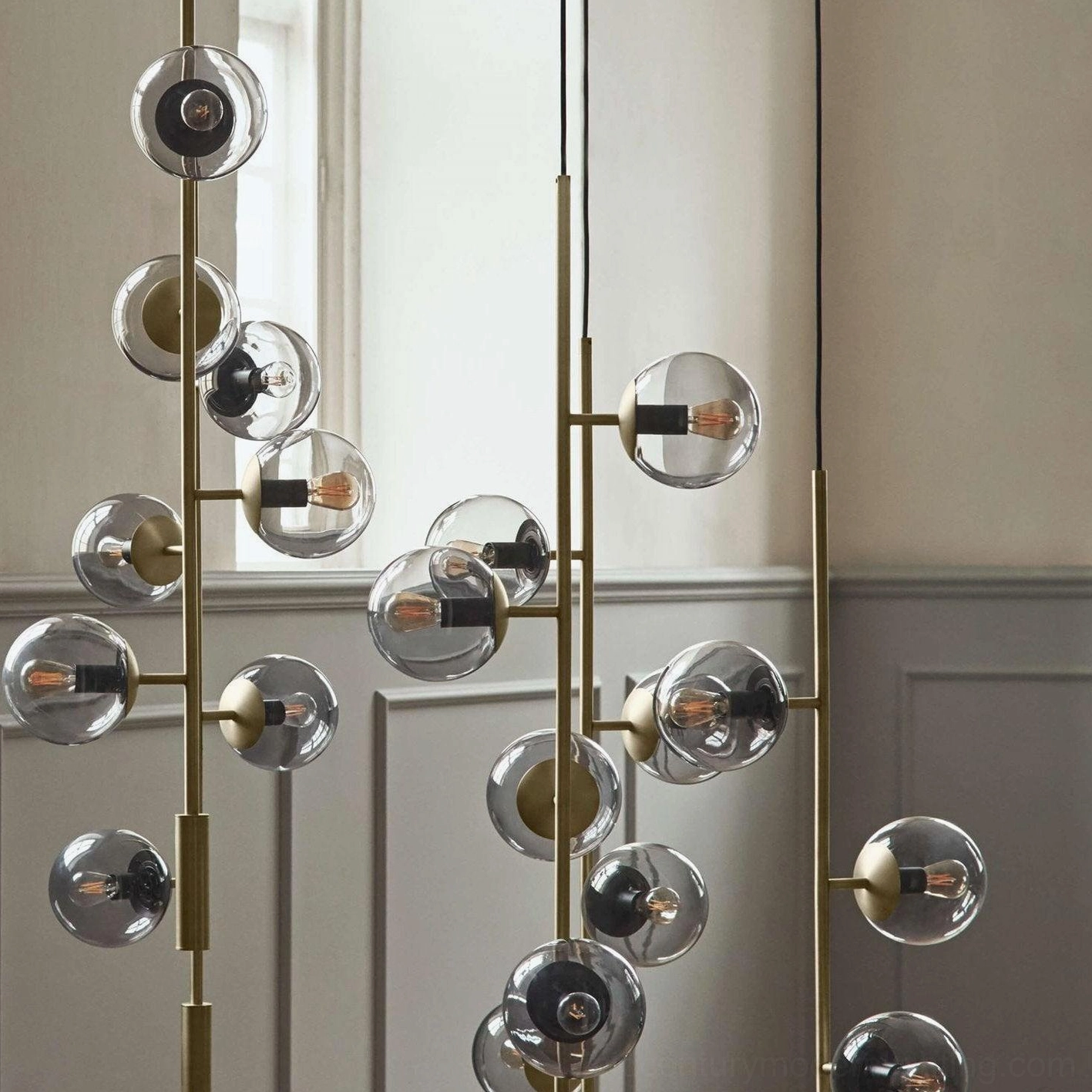 Close-up detail of mid-century modern orb pendant with brass hardware and mixed glass finish