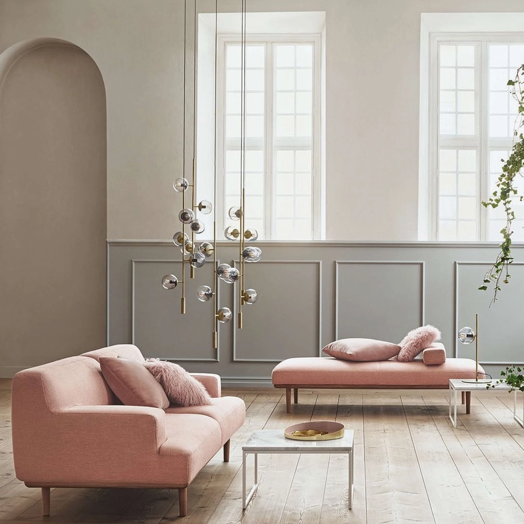 Orb pendant light installed in Nordic-style living room with minimalist brass design