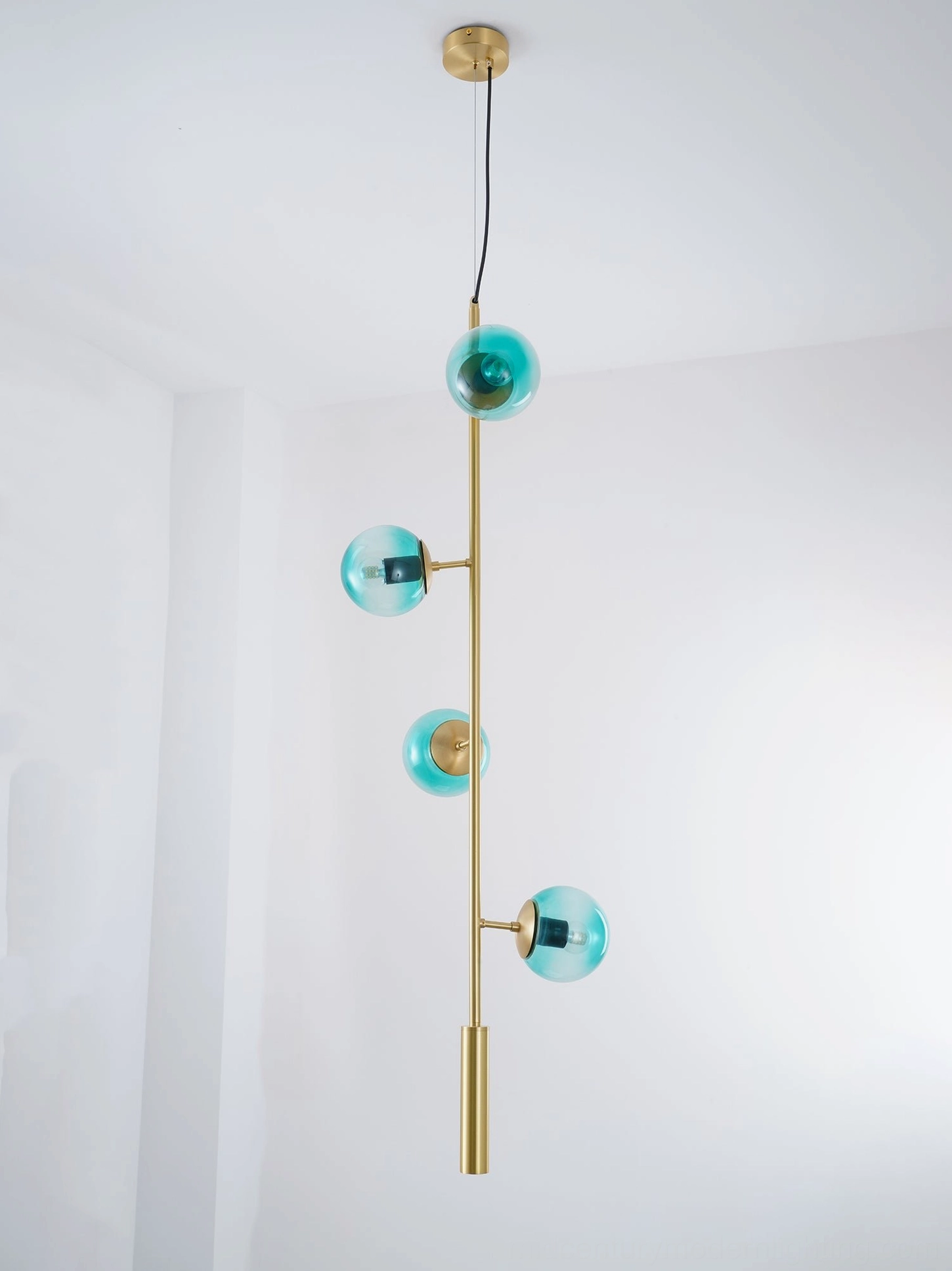 Orb pendant light with polished brass finish and frosted glass in modern home design