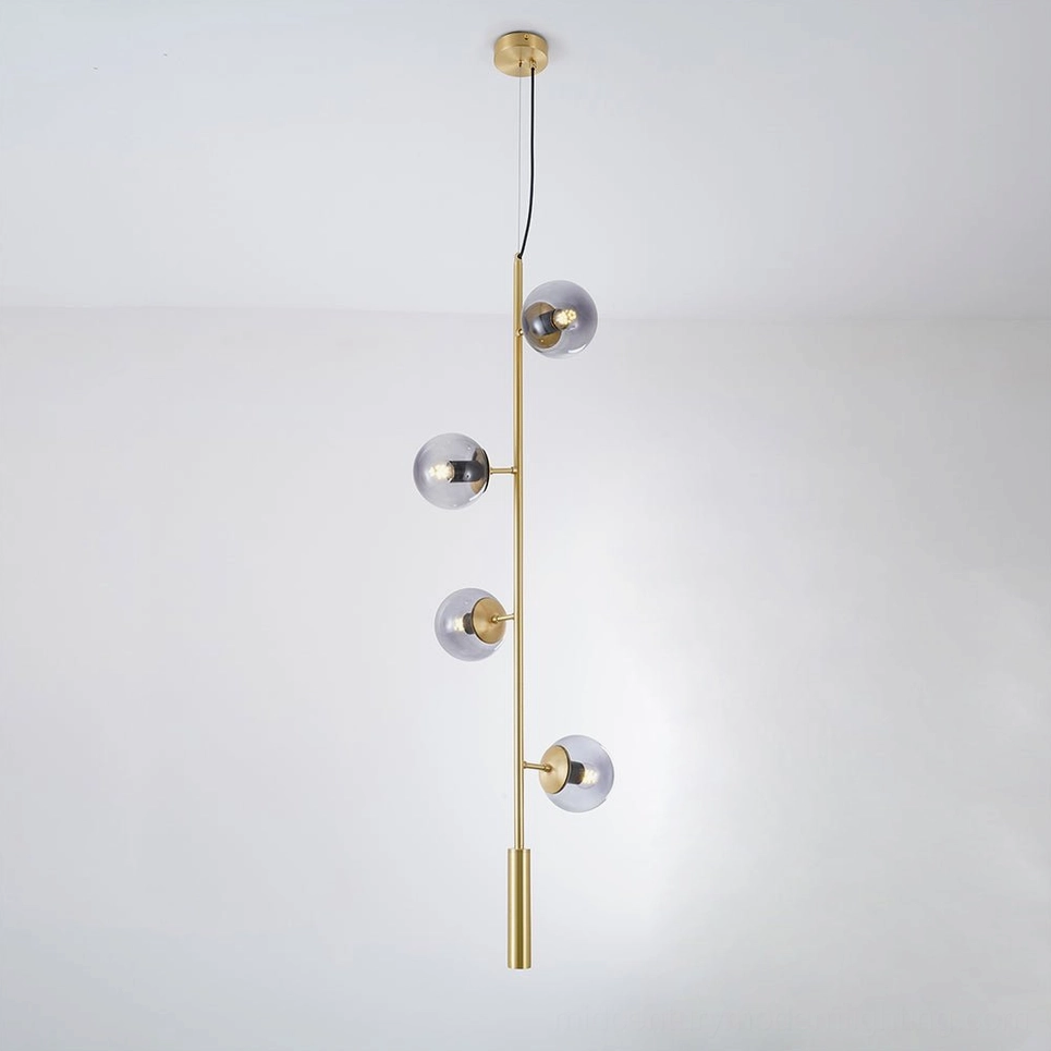 Linear orb pendant fixture with smoked glass shades and brass hardware, studio lighting