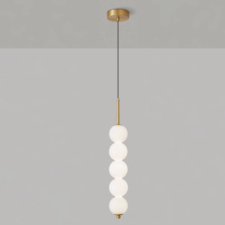 Five-orb Orbet pendant lamp in brass finish showing stacked sphere arrangement