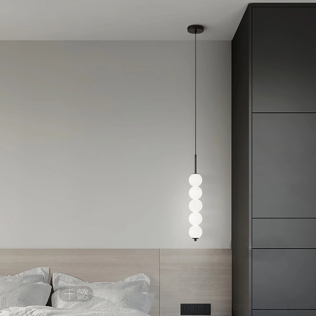 Tall eight-orb Orbet pendant lamp with frosted glass spheres installed in contemporary bedroom