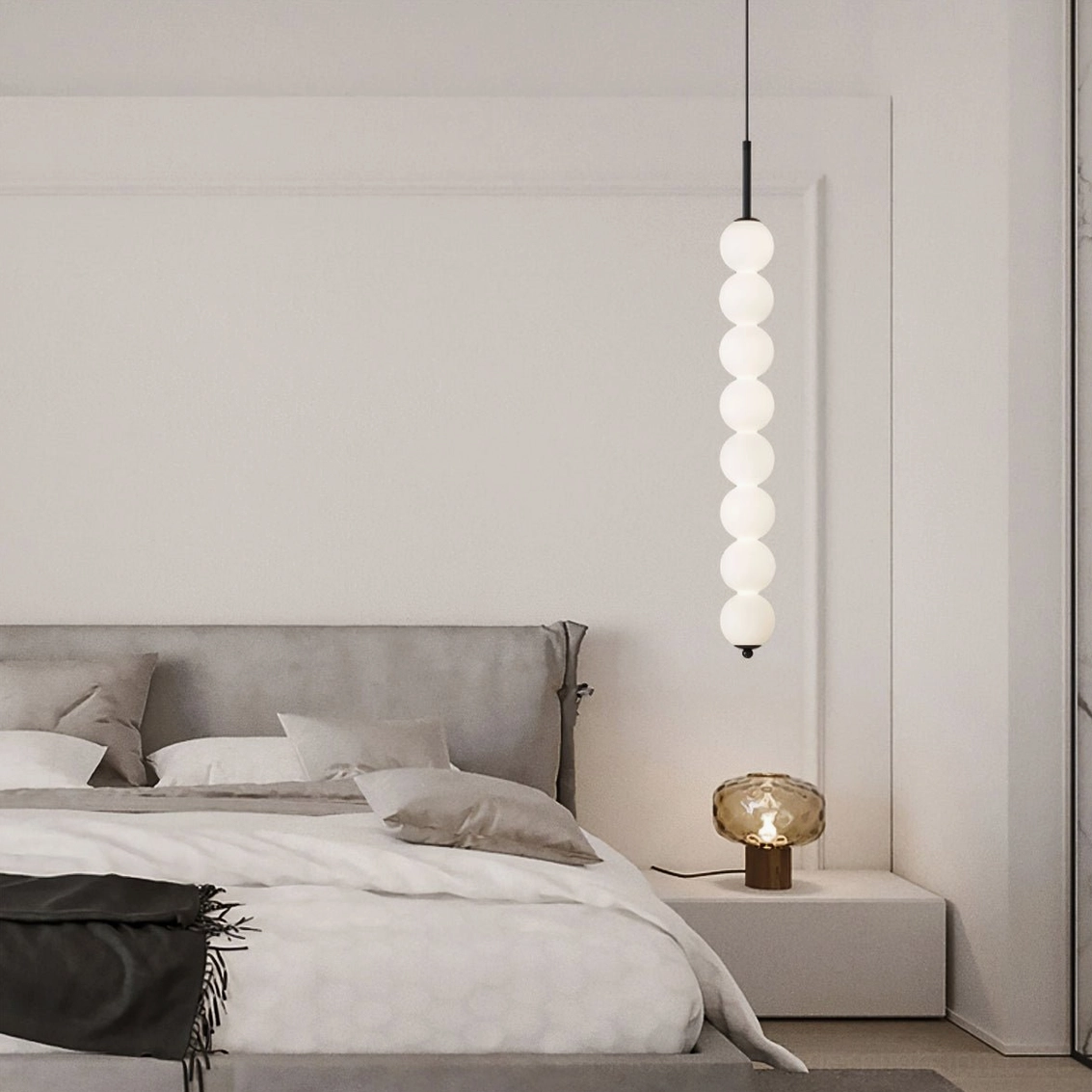 Long eight-orb Orbet pendant lamp in matte black finish suspended in contemporary master bedroom