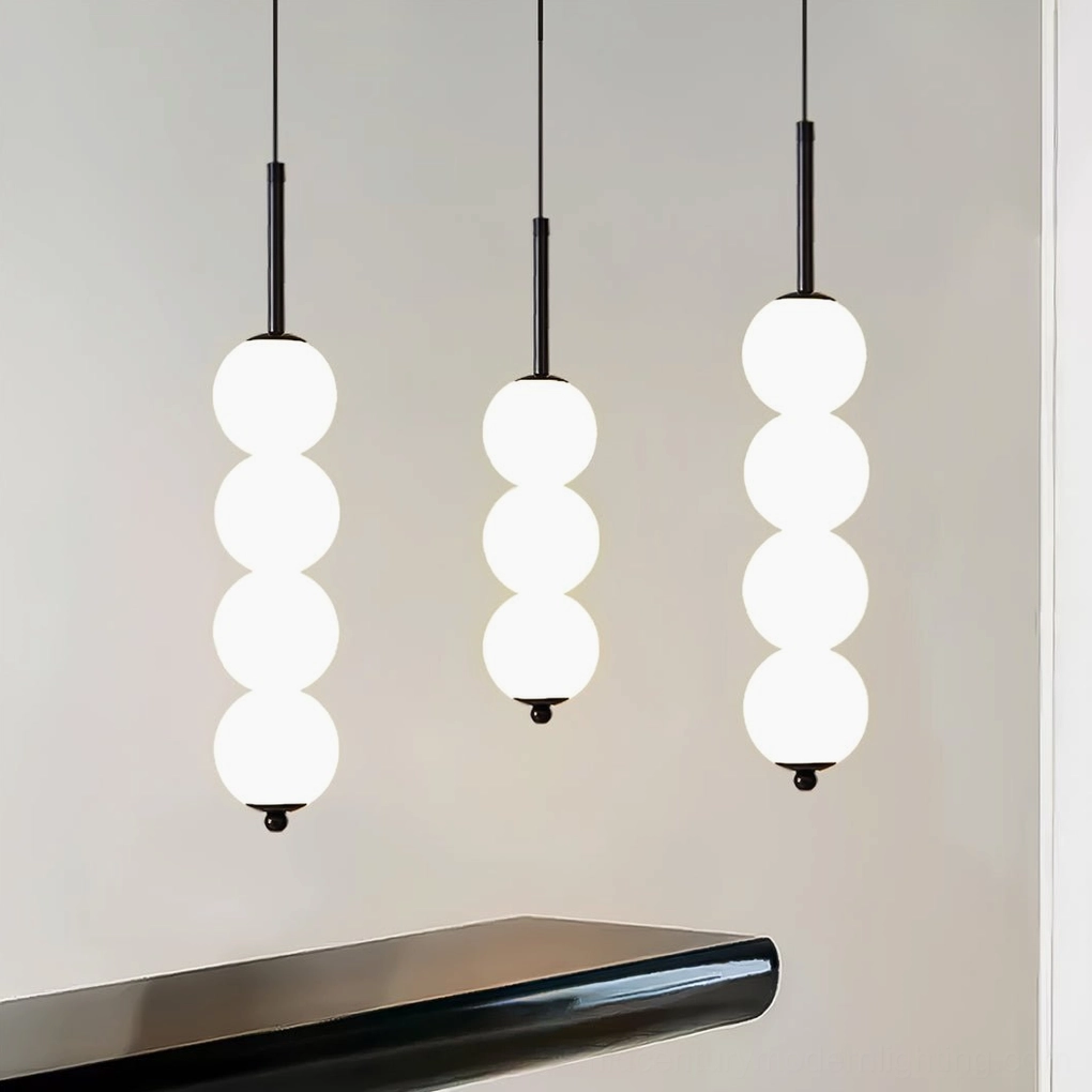 Orbet milk glass pendant lamp detail showing frosted glass orb diffusion and metal banding