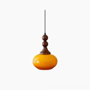 Orbique mid-century modern pendant light with amber glass shade and stacked walnut wood finial, studio overhead view