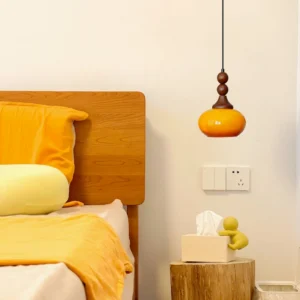 Orbique pendant light installed in warm mid-century modern bedroom with wood bed frame and vintage decor