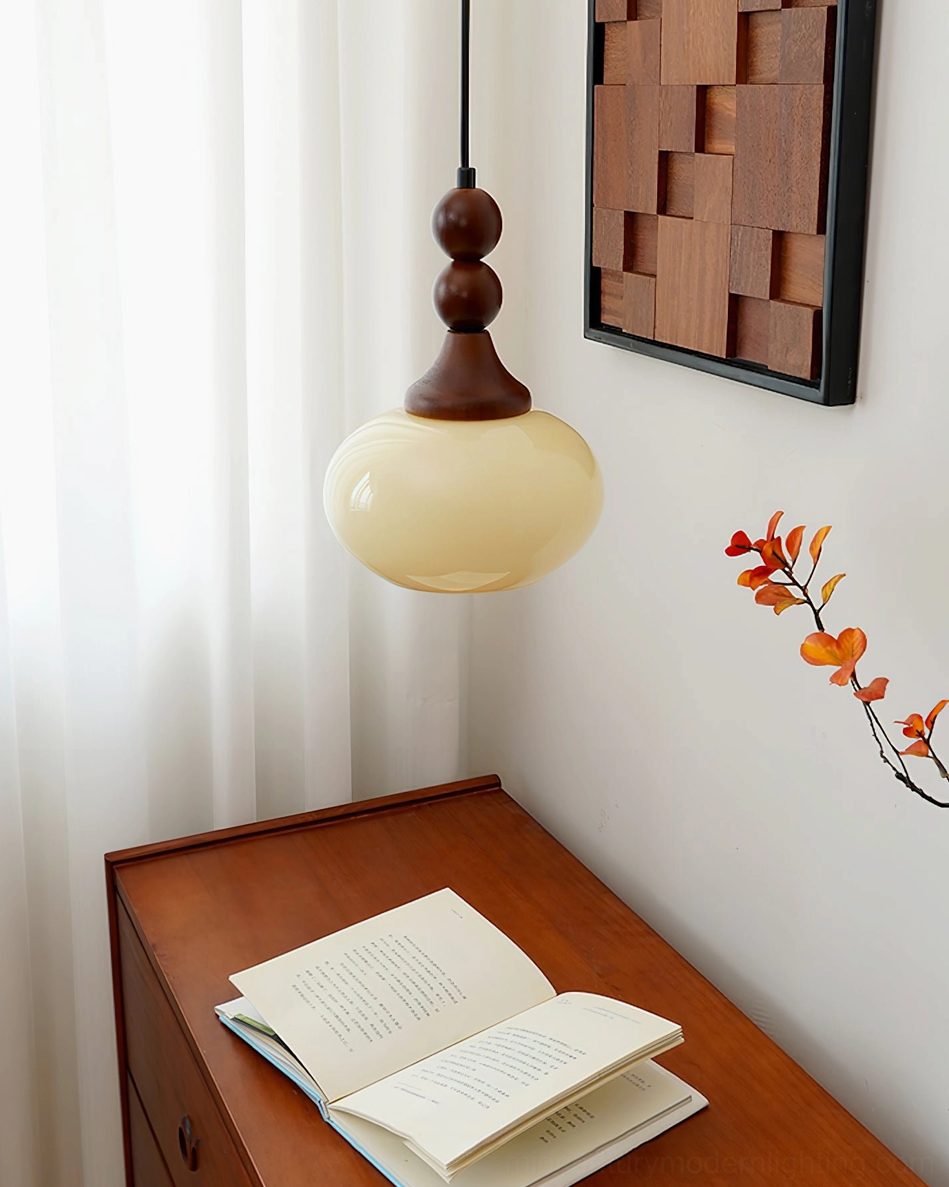 Orbique cream glass pendant light in minimalist bedroom corner with sheer curtains and side table