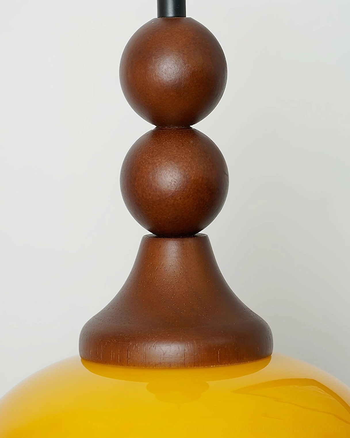 Close-up detail of Orbique pendant light wooden finial assembly showing stacked walnut spheres