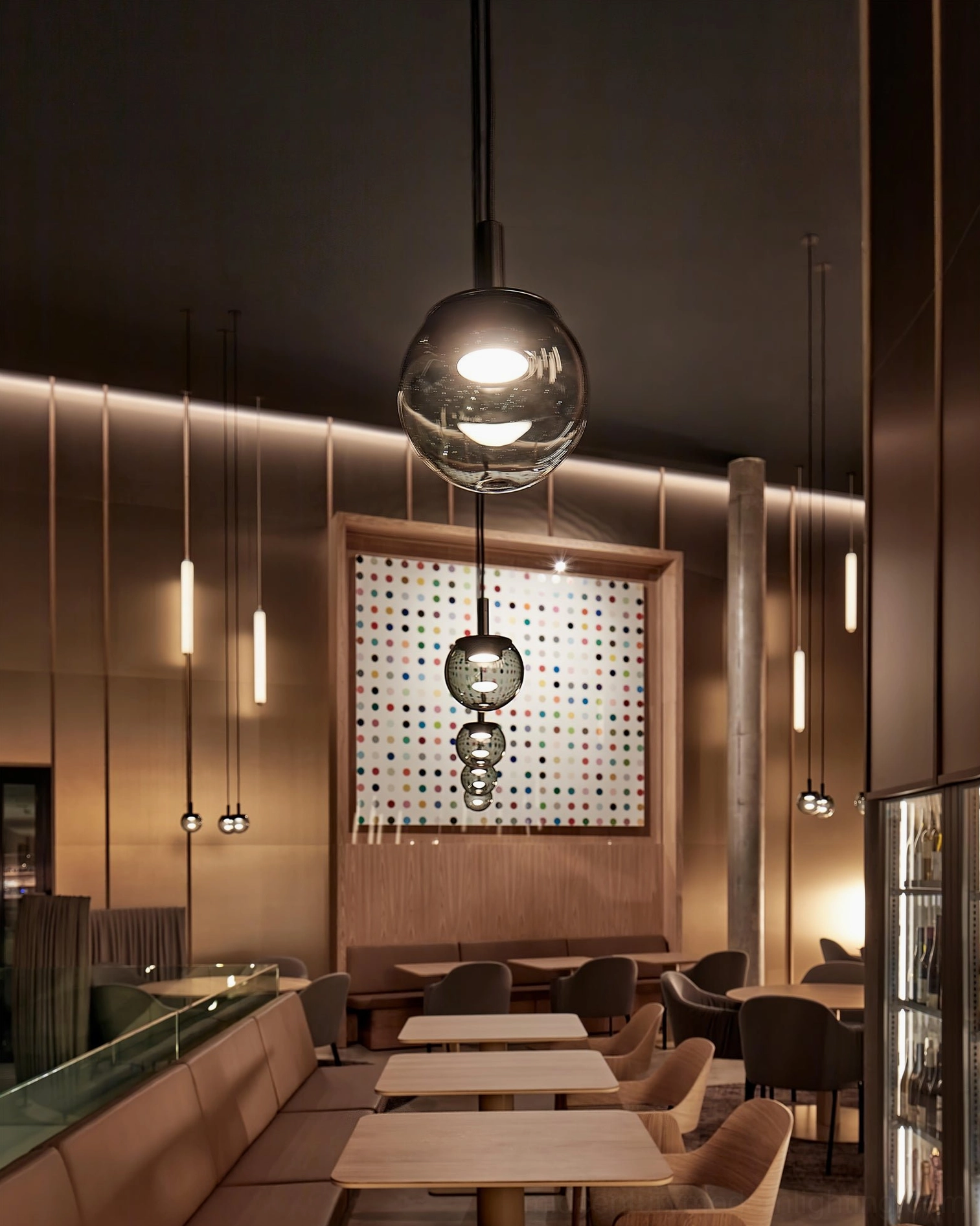 Orbis cluster pendant lighting in upscale modern restaurant setting - warm ambient spherical glass fixtures