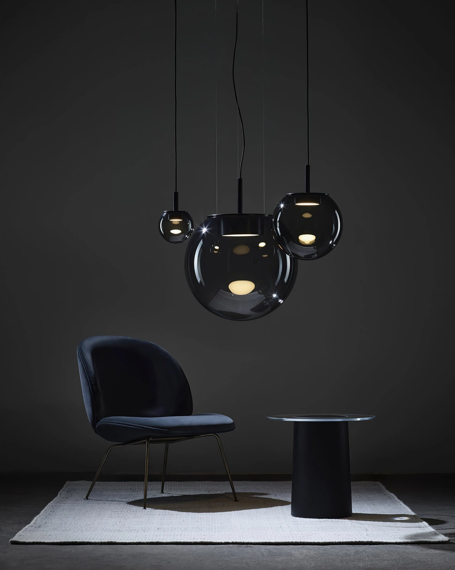 Dark smoked Orbis cluster pendant lamps - modern luxury seating corner with tinted glass globes