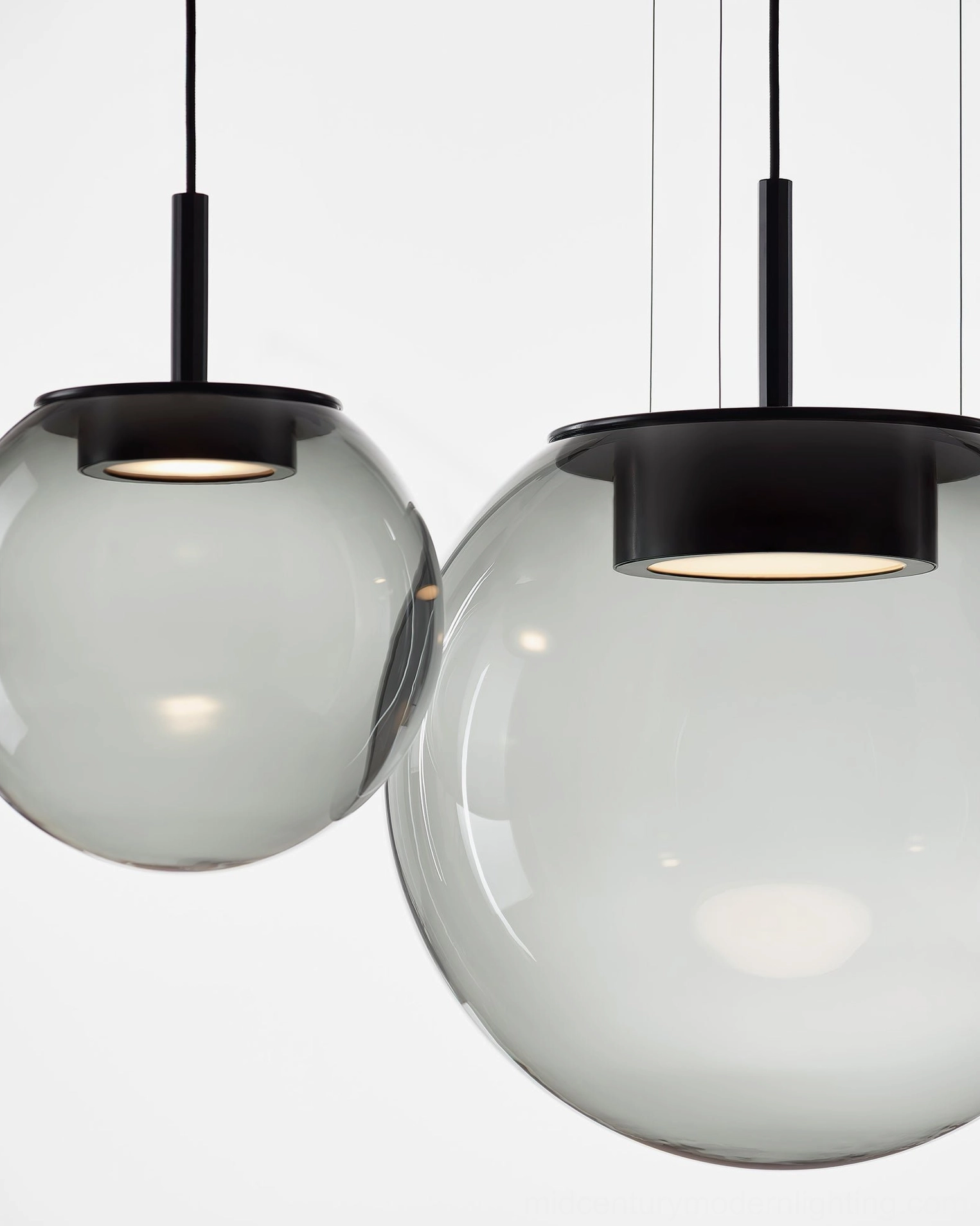 Orbis handblown glass pendant - smoke grey finish with warm light glow contemporary minimalist design