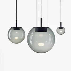 Orbis pendant lamps in three sizes - smoke grey and clear glass spheres with black metal hardware - contemporary dining lights