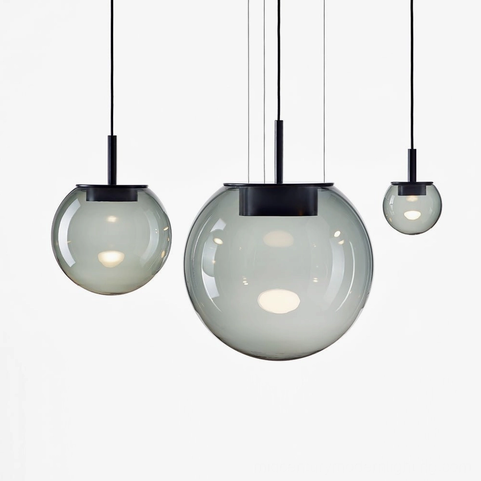 Orbis pendant lamps in three sizes - smoke grey and clear glass spheres with black metal hardware - contemporary dining lights