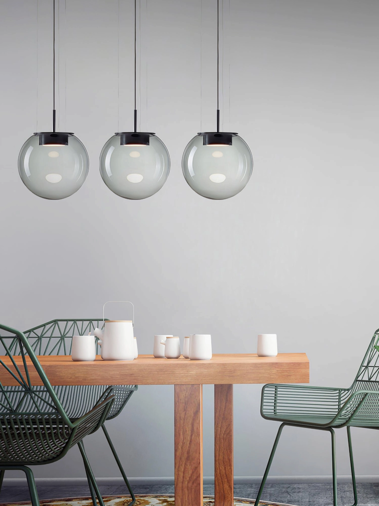 Three matching Orbis smoke glass pendant lamps - small residential dining room contemporary trio installation