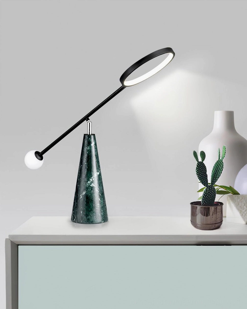 Orbit marble lamp showcasing green stone base with natural veining and black metal construction