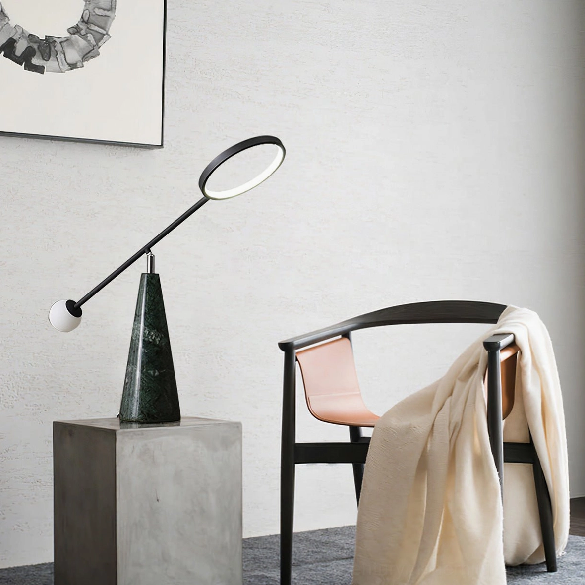 Postmodern Orbit marble table lamp displayed on concrete pedestal, minimalist living room corner
