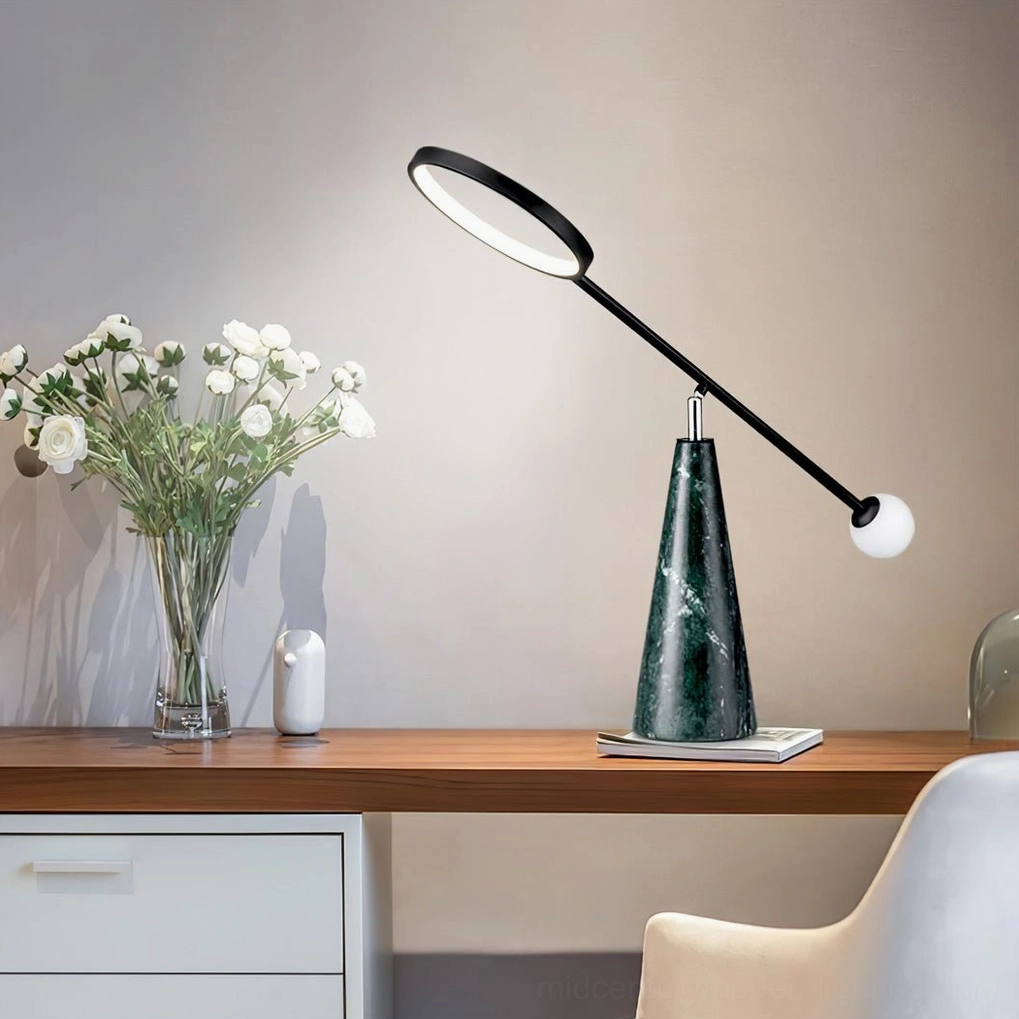Contemporary Orbit table lamp in home office workspace with flower vase and decorative items