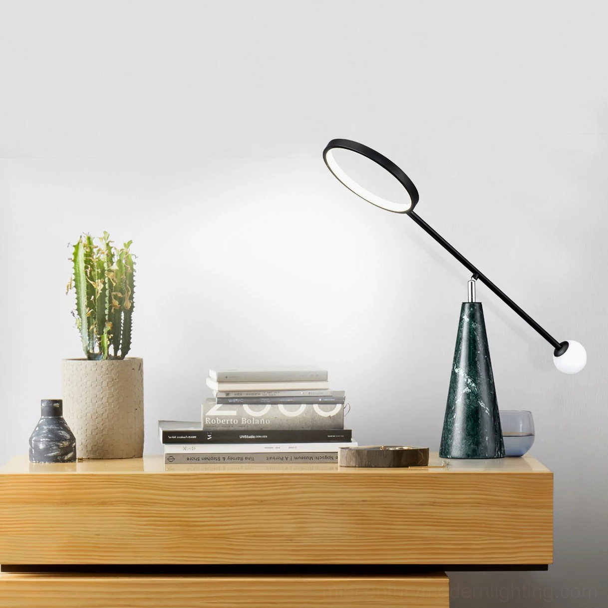 Orbit adjustable table lamp styled on wooden dresser with succulent plant and stacked books