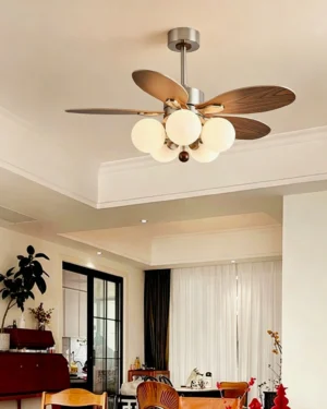 Modern ceiling fan light installed in warm vintage open living and dining space, showcasing sculptural glass sphere design integrated with contemporary home decor