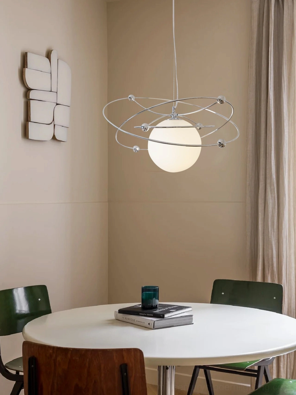Full view of orbital pendant light emphasizing polished chrome frame and frosted glass sphere