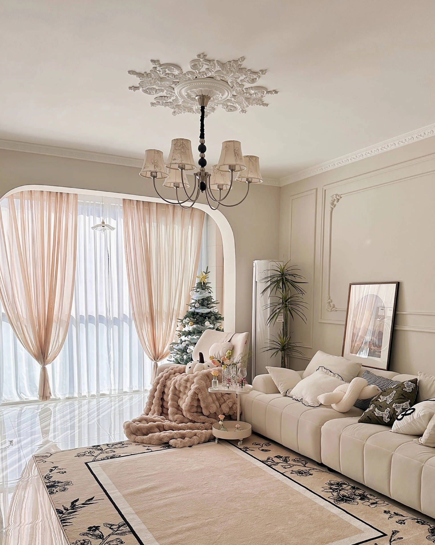 Six-head fabric chandelier with light metal frame in cozy French-inspired living room with warm lighting