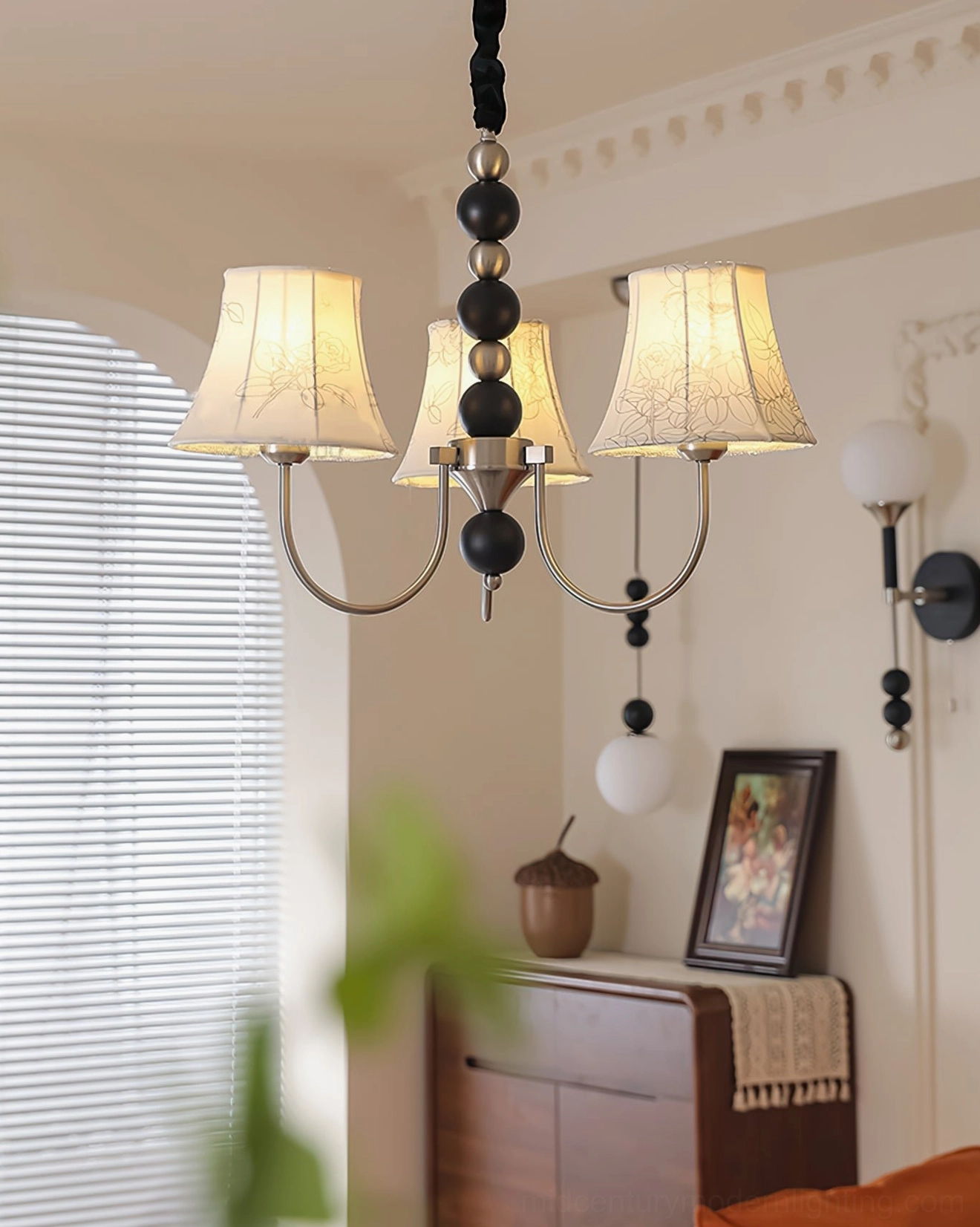 Mid-century modern pendant light with fabric shades in contemporary interior, showing warm light diffusion