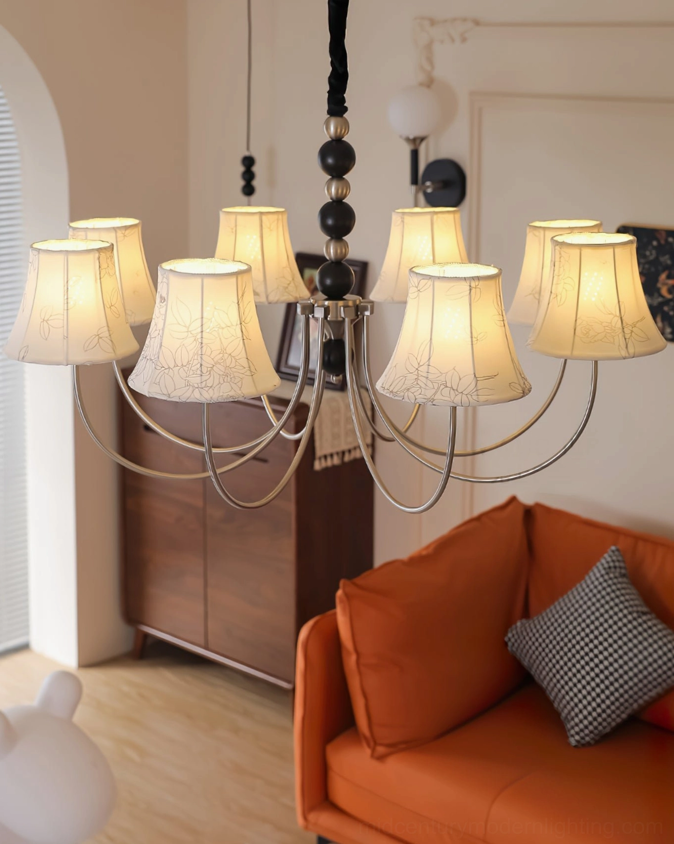 Fabric pendant light with vintage aesthetic and black twisted cord, eye-level view in warm modern interior