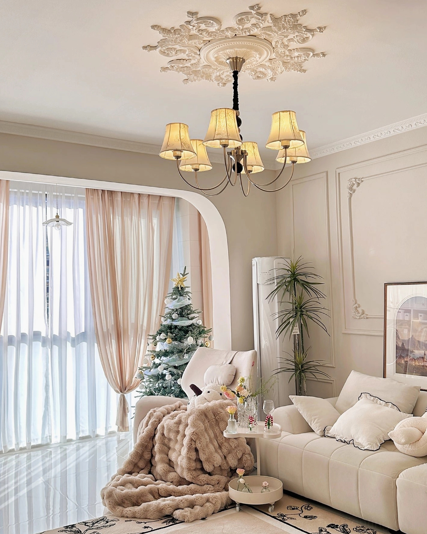 Mid-century modern fabric chandelier decorated for holidays in elegant living room with Christmas decor