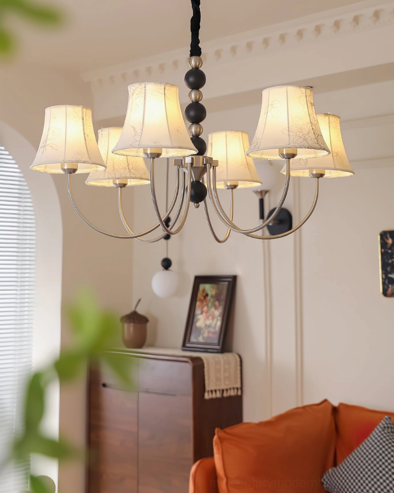 Classic vintage fabric chandelier with multiple heads in warm-toned living room, close-up eye-level angle