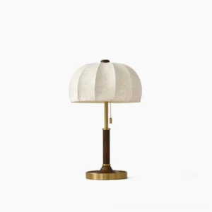 Orchid fabric table lamp with pumpkin shade and brass metal base on white studio background, front view