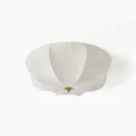 Orchid fabric ceiling light flat lay studio shot showing off-white scalloped shade with botanical floral print and brass metal base